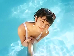 Sexy asian girl wearing heels in the pool.